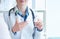 Female medicine doctor hand hold jar of pills second hand points to the medicine.Young doctor talks to patient about the