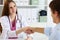 Female medicine doctor shake hand as hello with male patient