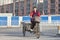 Female migrant worker on a freight bike, Beijing, China