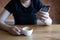 Female model holds modern smart phone relaxing in cafe coffee