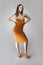 Female Model Wearing a Mustard Colored Dress