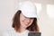 Female model wearing a white baseball cap. White cap mockup, template for picture, text or logo. Girl with a cap holding