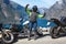 Female motorcyclist from bikers group triumphs on the mountain road overlooking the Norwegian fjords and nature, travel on Norway