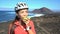 Female mountain biker eating healthy fruit on bike break in nature landscape