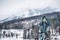 Female mountain biker standing outdoors in winter nature, focus on background.