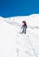 Female mountaineer ascending a glacier.