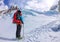 Female mountaineer with backpack, helmet and harness with climbing in mountain