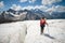 Female mountaineer enjoying the beauty of the glacier walks on the glacier in the crampon and sunglasses. Against the