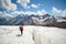 Female mountaineer enjoying the beauty of the glacier walks on the glacier in the crampon and sunglasses. Against the