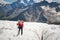 Female mountaineer enjoying the beauty of the glacier walks on the glacier in the crampon and sunglasses. Against the