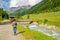 Female mountaineer by mountain stream in Alps