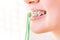 Female mouth with braces closeup with toothbrush in profile