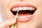 Female mouth with braces and interdental brush