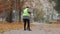 Female municipal utility worker sweeping street, low paid job, poverty