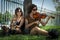 Female musicians seated under a tree playing instruments