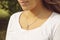 Female neckline wearing tiny silver chain with silver pendant