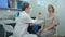 Female neurologist performing neurological tests on a female patient in an office