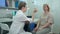 Female neurologist performing neurological tests on a female patient in an office