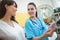 Female nurse assisting patient on digital tablet