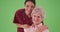 Female nurse or caregiver with senior elderly patient smiling on greenscreen