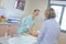 Female nurse caring baby near mother at hospital