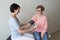 Female nurse checking blood pressure home elderly woman