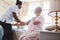 Female nurse checking blood pressure of a senior woman