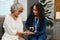 Female nurse checking blood sugar level with glucose meter of senior woman. Diabetes, health and age lifestyle concept