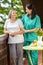 Female nurse consoling elderly woman at home