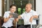 Female nurse discussing over digital tablet with senior man in wheelchair