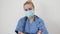 Female nurse or doctor. Young pretty woman in blue clothes with medical mask posing