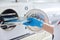 Female nurse doing sterilization of dental medical instruments in autoclave