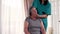 Female nurse giving head massage to senior woman at home