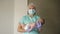 Female nurse holding a newborn baby in hospital.