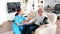 Female nurse looking after an old patient with Alzheimer disease sitting on the sofa in nursing home