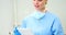 Female nurse using digital tablet in clinic