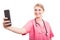 Female nurse wearing scrubs taking selfie with smartphone
