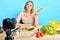 Female nutrition expert looks aside, thinks what to cook out of raw vegetable