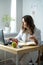 A female nutritionist endocrinologist working in her office. Focused look at the camera