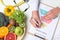 Female nutritionist with food pyramid chart at table