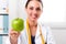 Female nutritionist giving a Green Apple