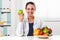 Female nutritionist holding a green apple