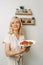 A female nutritionist holds sandwiches with adjika in her hands