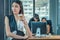 Female office woman take abreak from working by standing beside window with having coffee