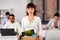 Female office worker with box of personal stuff