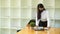 Female office worker with face mask working with paperwork in her office