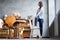 Female office worker stand in yoga pose twisting spine using chair.