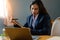 Female office worker wears dark blue business suit working with document file and pile of work paper in serious emotional face in