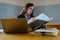 Female office worker wears dark blue business suit working with document file and pile of work paper in serious emotional face in