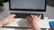 female office worker working on laptop and typing on the keyboard, close-up hands